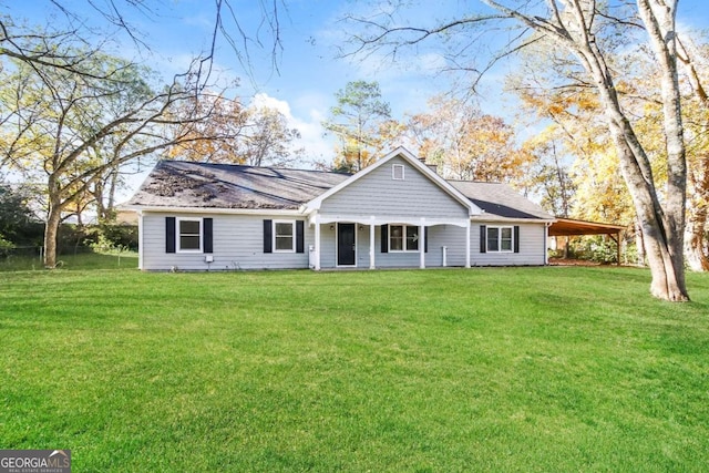 view of front facade with a carport and a front lawn