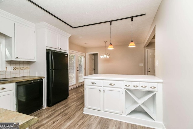 kitchen featuring black appliances, decorative light fixtures, white cabinets, and a textured ceiling