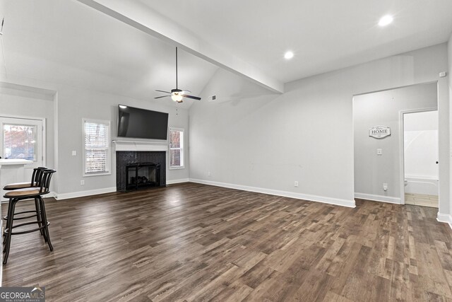 unfurnished living room with vaulted ceiling with beams, ceiling fan, and dark wood-type flooring