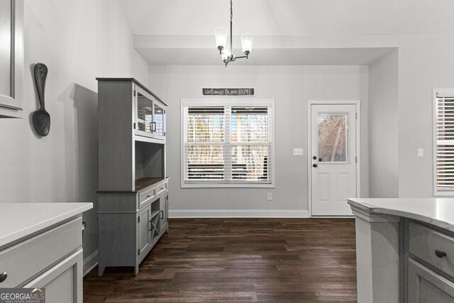 interior space with a chandelier and dark wood-type flooring