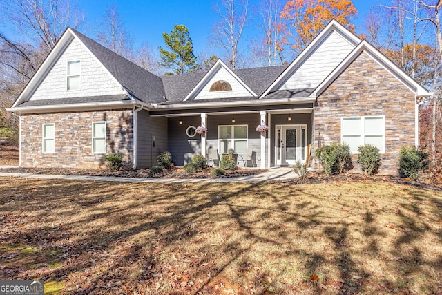 view of front of property featuring a front yard and covered porch