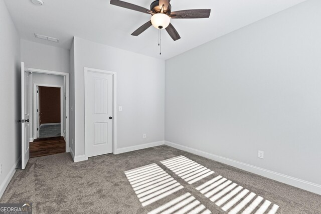 unfurnished bedroom with ceiling fan and carpet