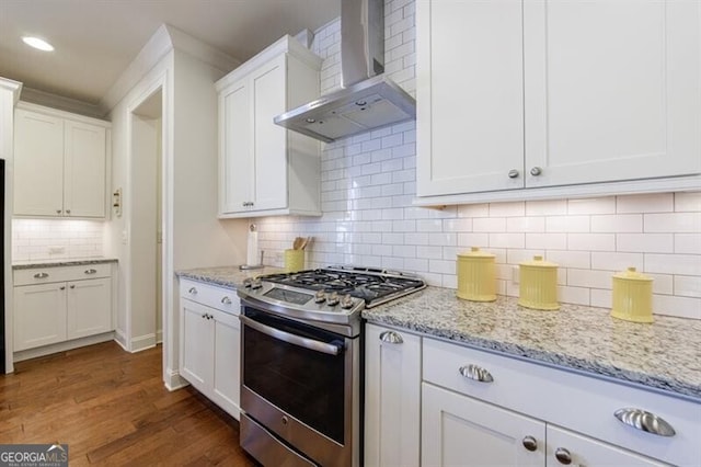 kitchen featuring gas stove, white cabinetry, wall chimney exhaust hood, tasteful backsplash, and dark hardwood / wood-style flooring