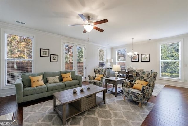 living room featuring wood-type flooring, crown molding, and a healthy amount of sunlight