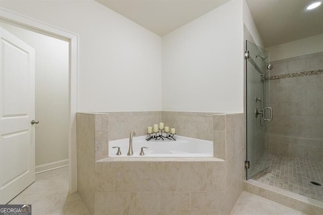 bathroom with separate shower and tub and tile patterned flooring