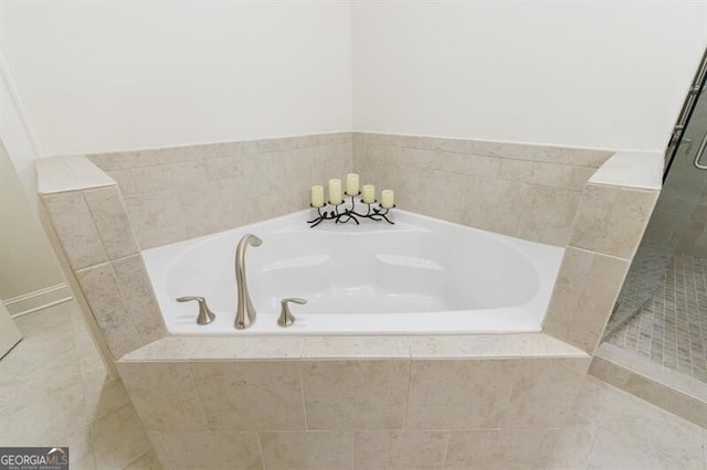 bathroom with tile patterned flooring and separate shower and tub