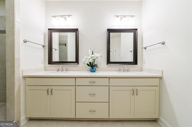 bathroom featuring a tile shower and vanity