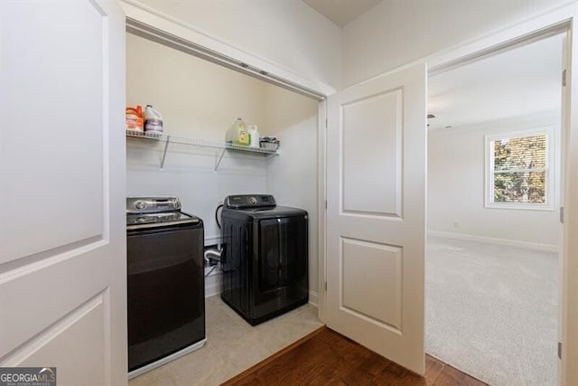 laundry area featuring wood-type flooring and washing machine and clothes dryer