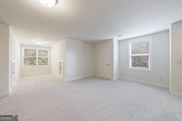 spare room with light carpet