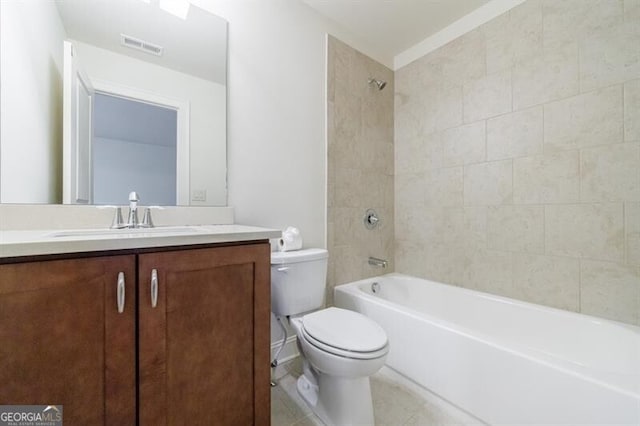 full bathroom with tile patterned floors, vanity, tiled shower / bath combo, and toilet