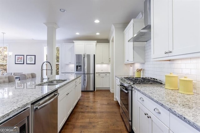 kitchen with wall chimney exhaust hood, stainless steel appliances, dark wood-type flooring, sink, and white cabinets