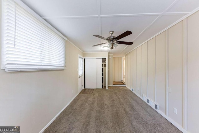 empty room featuring carpet flooring and ceiling fan