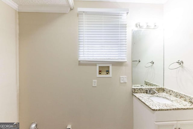 bathroom with vanity, a textured ceiling, and ornamental molding