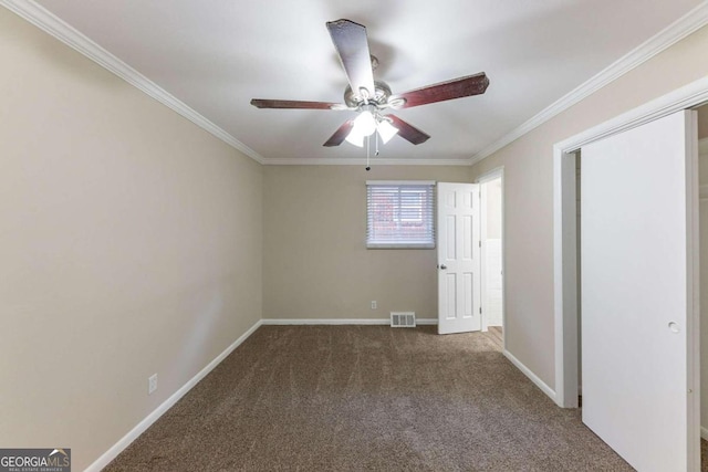 unfurnished bedroom featuring carpet, ceiling fan, and crown molding