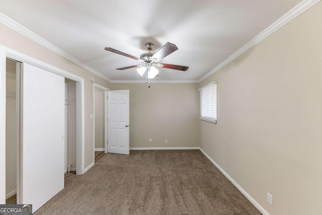 unfurnished bedroom featuring ceiling fan, carpet floors, and ornamental molding