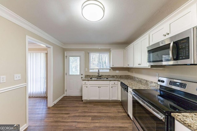 2363 Dabney Ter, Atlanta, GA 30344 - kitchen featuring appliances with stainless steel finishes, crown molding, dark wood finished floors, white cabinetry, and light stone countertops