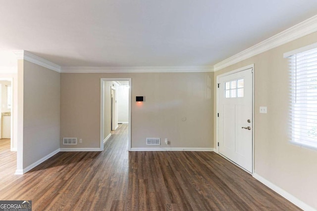 foyer entrance featuring a wealth of natural light, dark wood-type flooring, and ornamental molding