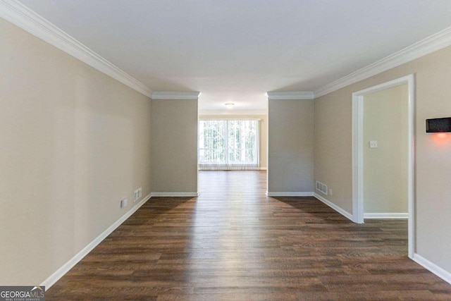 spare room featuring dark wood-type flooring and ornamental molding