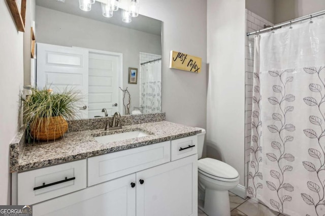 bathroom featuring tile patterned floors, vanity, and toilet