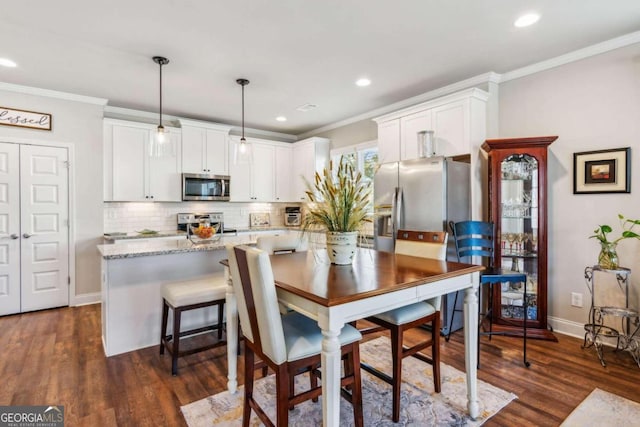 dining space with dark hardwood / wood-style floors and crown molding