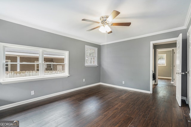 spare room featuring dark hardwood / wood-style floors, ceiling fan, ornamental molding, and a wealth of natural light