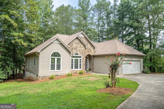 view of front of house with a garage and a front lawn