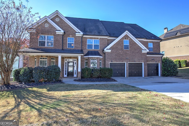 view of front of house featuring a garage and a front lawn