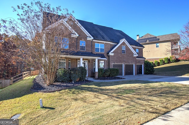 view of front of property featuring a garage and a front lawn