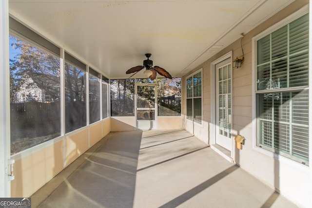 unfurnished sunroom with a wealth of natural light and ceiling fan