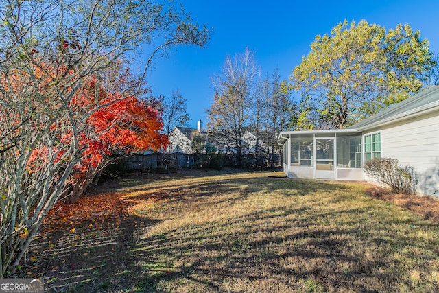 view of yard with a sunroom