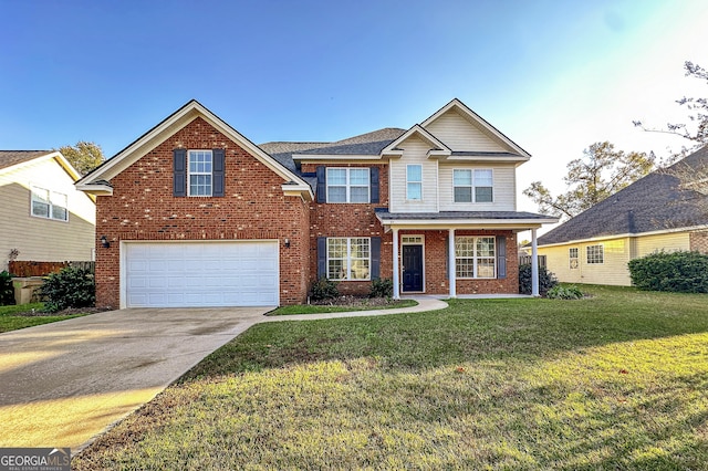 view of front of home with a front yard and a garage