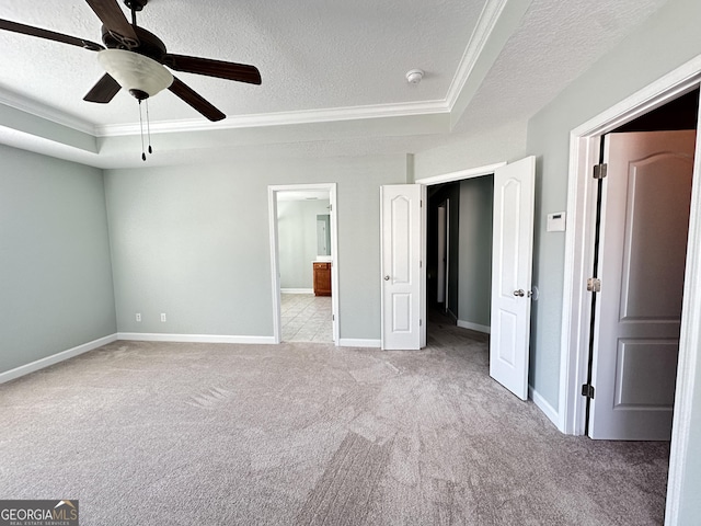 unfurnished bedroom with ceiling fan, crown molding, light carpet, and a textured ceiling