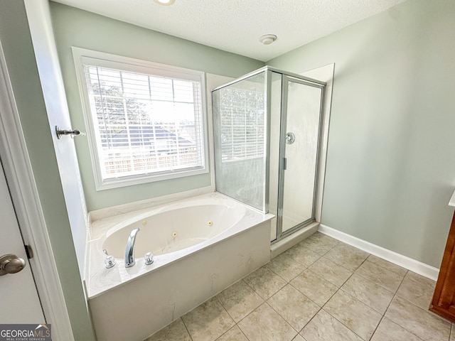 bathroom featuring plus walk in shower, a textured ceiling, and tile patterned flooring