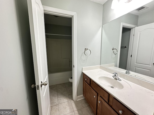 bathroom with tile patterned floors, vanity, and toilet