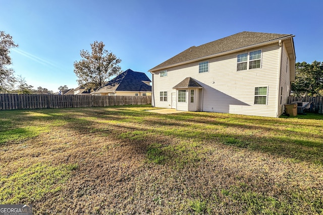 back of house featuring a yard