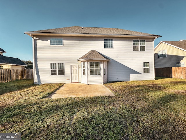 rear view of house featuring a yard and a patio area