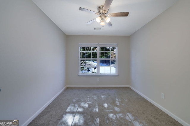 carpeted empty room featuring ceiling fan