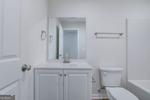 bathroom with vanity, toilet, and a bathing tub