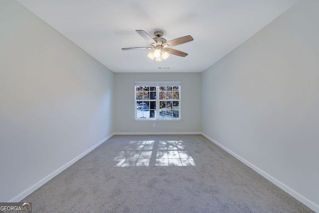 carpeted spare room with ceiling fan