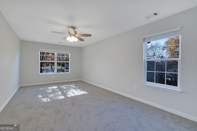 carpeted empty room featuring ceiling fan