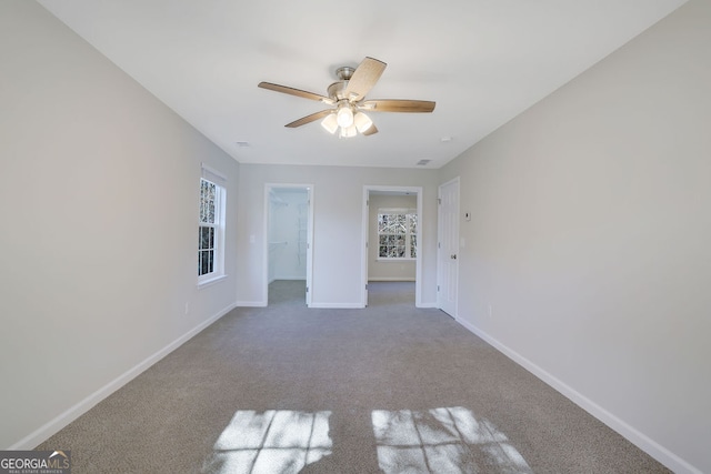 carpeted empty room featuring ceiling fan