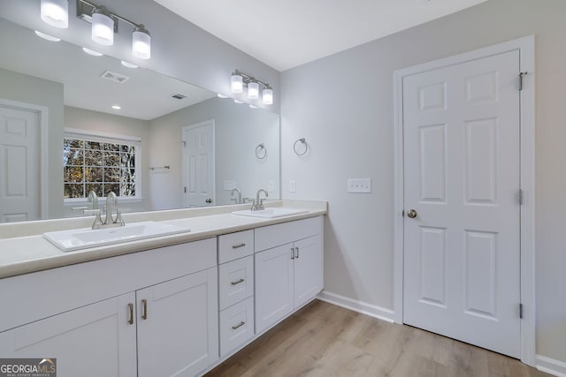 bathroom with hardwood / wood-style floors and vanity