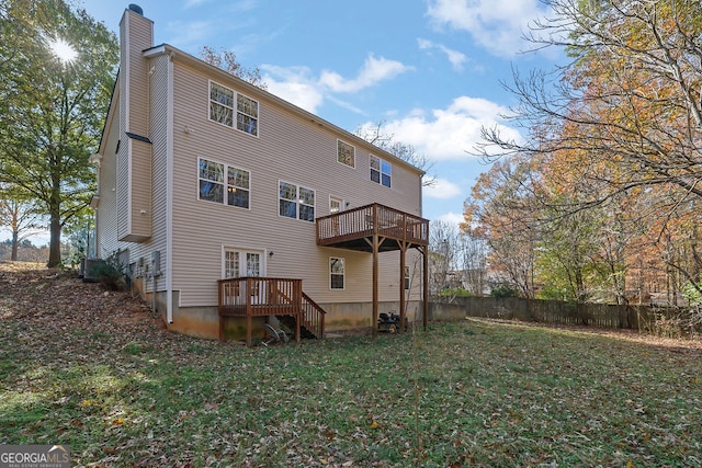 back of house with a yard and a wooden deck