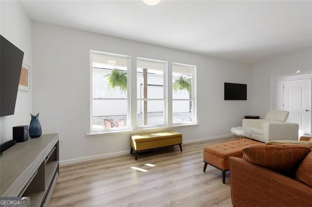 living area with light wood finished floors and baseboards