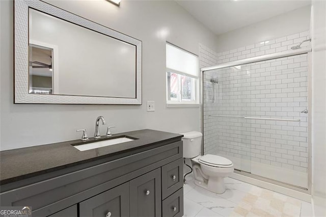 full bath featuring marble finish floor, a shower stall, toilet, and vanity