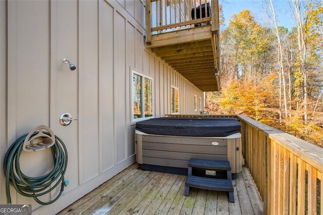 wooden terrace featuring a hot tub