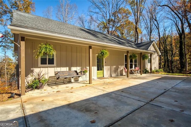 back of property with roof with shingles