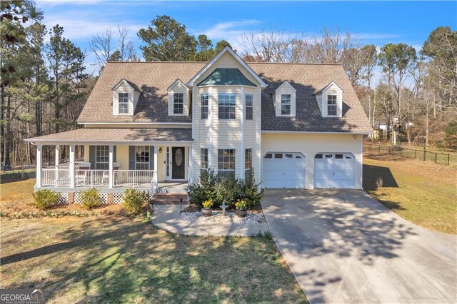 view of front of home with covered porch and a garage