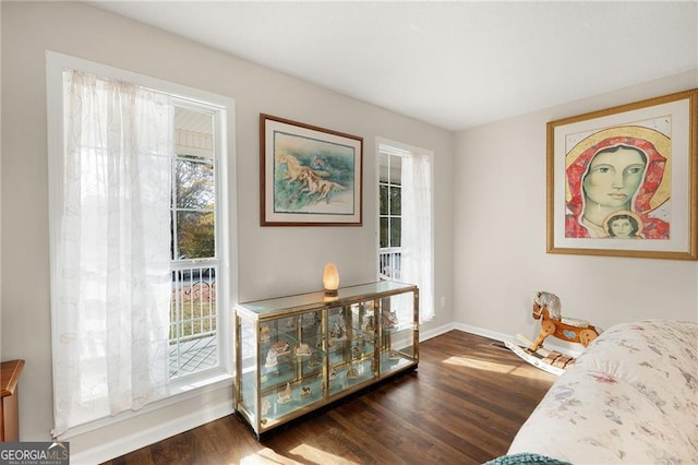 interior space with baseboards and dark wood-style flooring