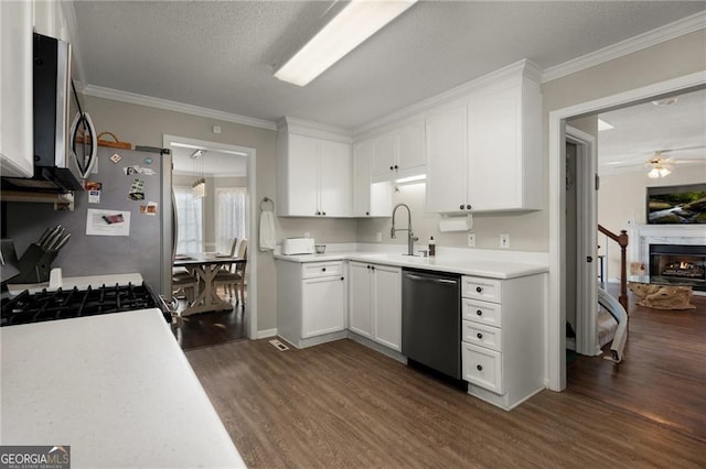 kitchen with dishwashing machine, a ceiling fan, a sink, range with gas cooktop, and stainless steel microwave